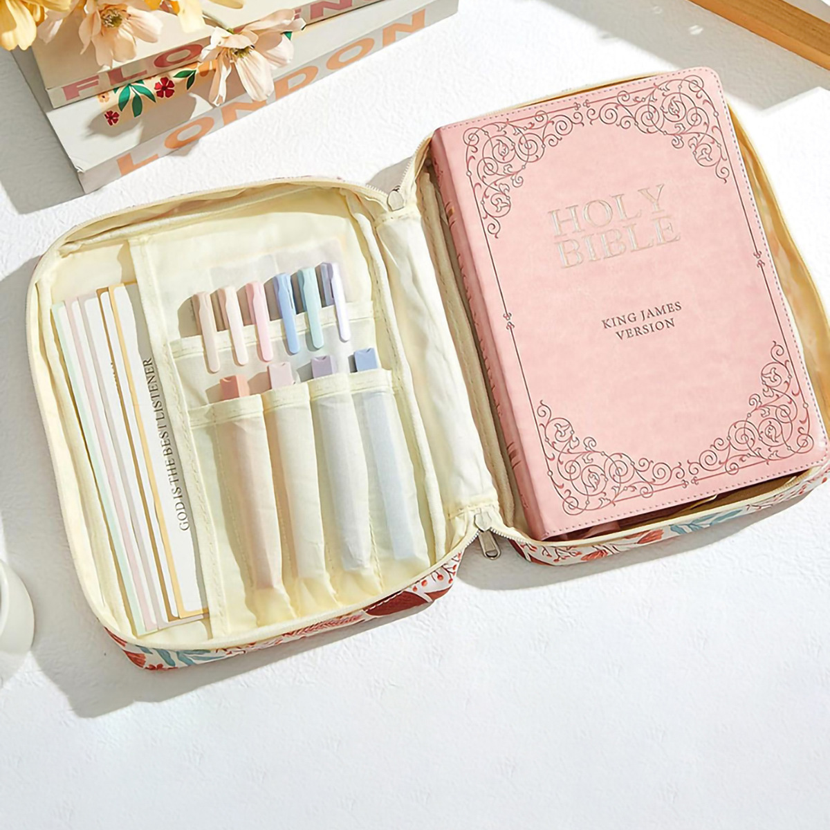 Supplier image of an open beige floral book pouch with example contents